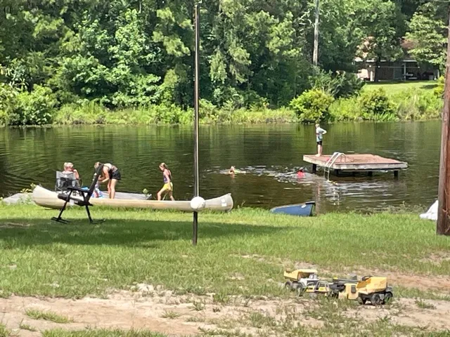 Family enjoying a summer day canoeing and swimming at the lake