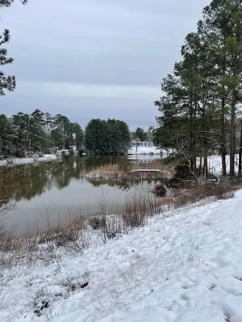 A peaceful East Texas lake blanketed in snow